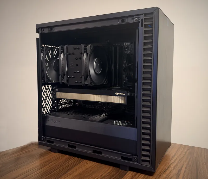 An AMW ai Vault with its side panel open on a desk: a full size office computer with a professional NVIDIA graphics card inside.
